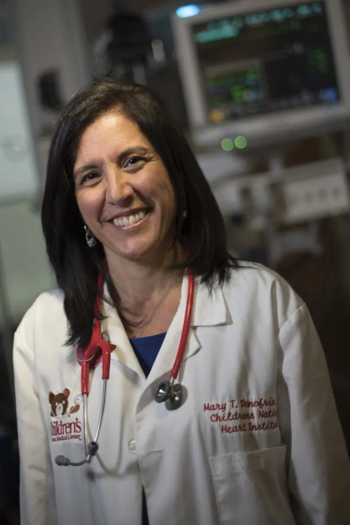 Smiling female doctor wearing a white coat.