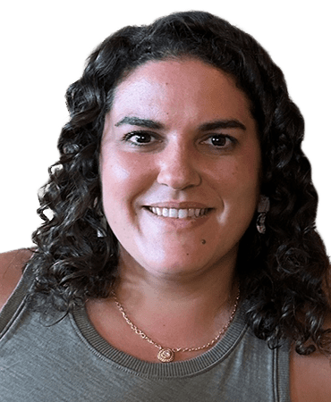 Smiling woman with curly hair and necklace.