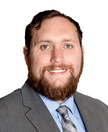 Man in suit with a beard and tie.