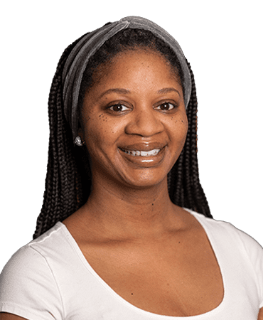 Woman smiling with gray headband.