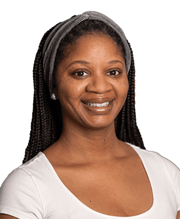 Smiling woman with grey headband and braids.