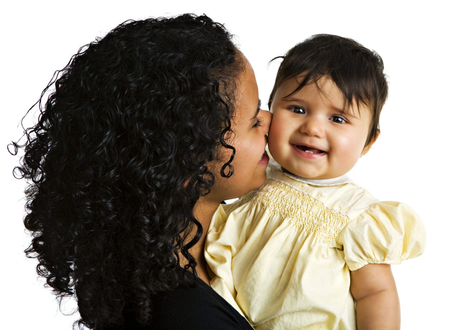 A Brazilian mom kissing her biracial baby. Isolated on white.