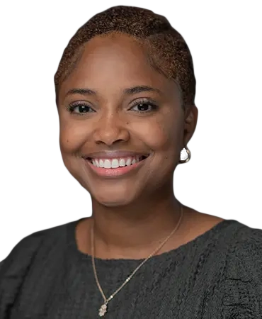 Woman smiling with short hair and necklace.