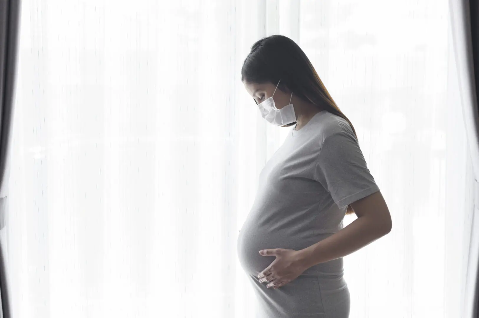 Young Pregnant Woman Wearing A Protective Mask And Expecting A B