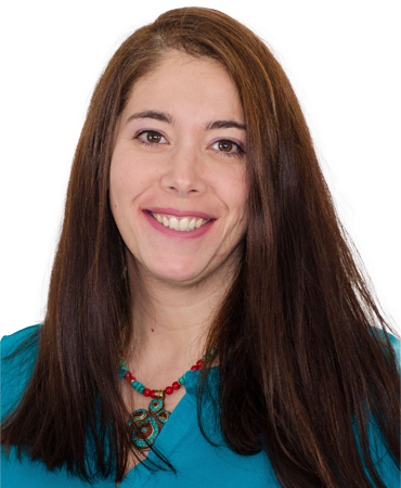 Smiling woman with long brown hair and turquoise necklace.