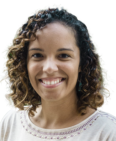 Smiling woman with curly brown hair.