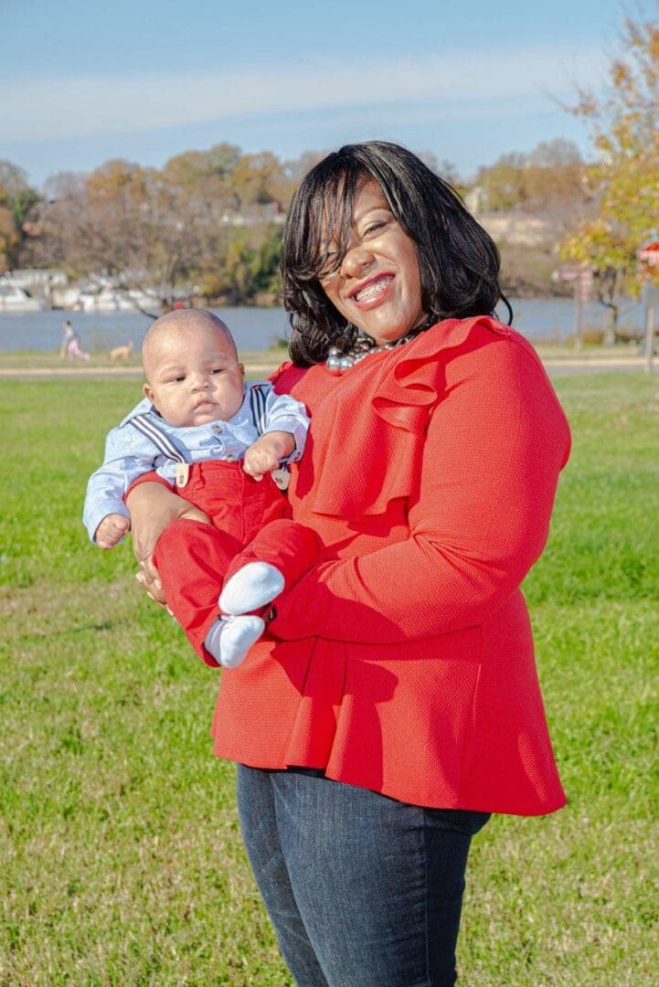 Happy woman holding adorable baby boy.