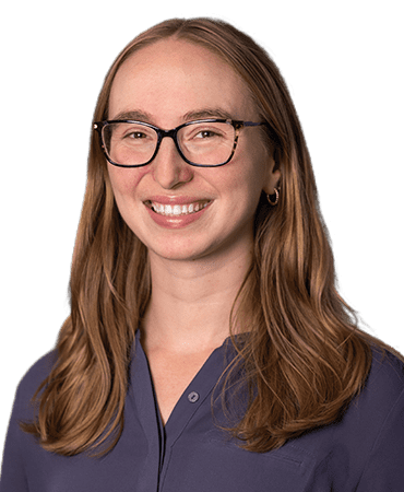 Woman with glasses and long brown hair.