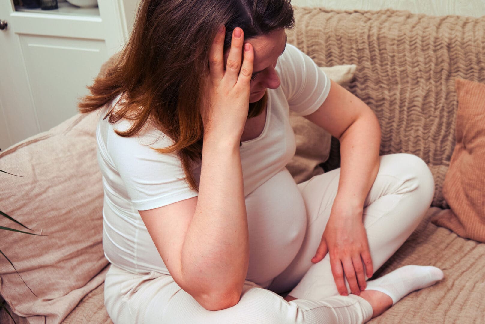 Caucasian pregnant woman having headache