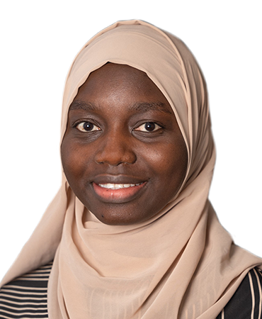 Mariama Dampha Smiling woman in light brown hijab and lined colors blazer.