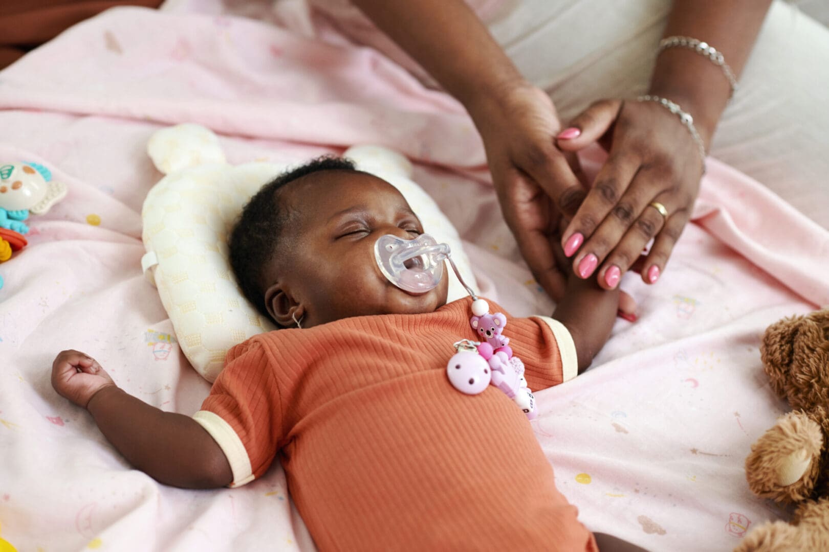 Sleeping Newborn Baby Mother touching hand of sleeping newborn baby