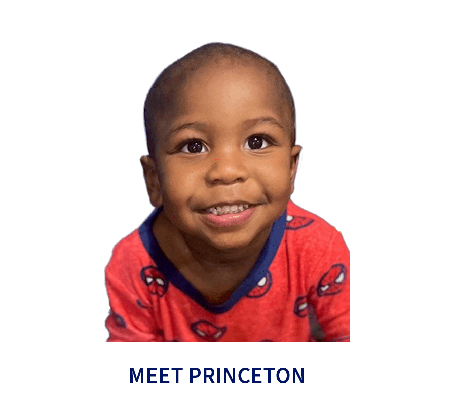 Smiling toddler in Spider-Man pajamas.
