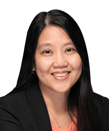 Smiling woman with long black hair in a black blazer.