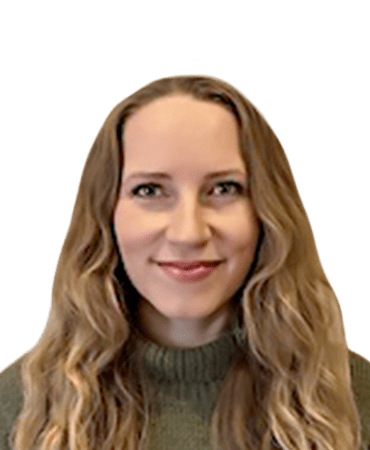 Smiling woman with long wavy hair and a green sweater.