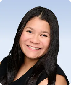 Smiling person with long dark hair.