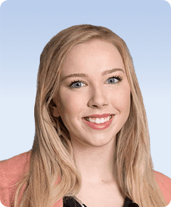 Smiling person with long blonde hair.