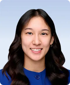Smiling person in a blue suit.