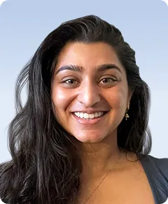 Smiling person with long dark hair.