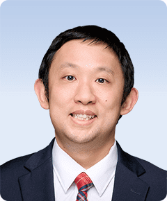 Man in suit with red plaid tie.