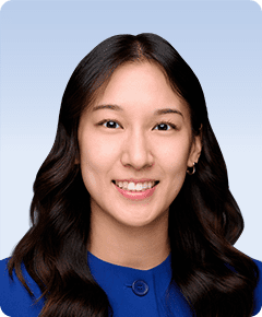Woman smiling in a blue outfit.