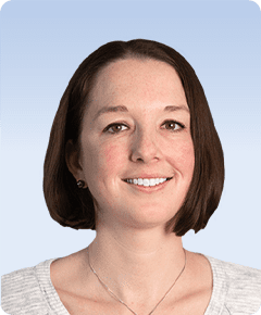 Smiling person with short brown hair.