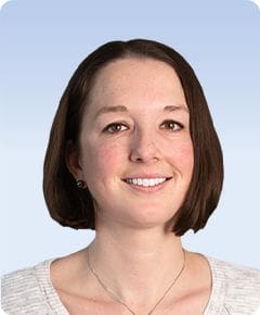 Smiling woman with short brown hair.