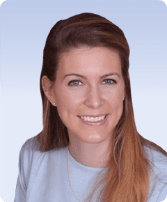 Smiling woman with long hair, blue shirt.