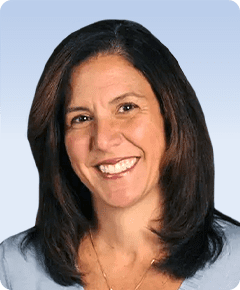 Smiling woman with shoulder-length dark hair.
