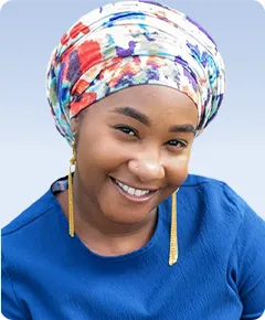 Smiling woman wearing colorful headscarf and earrings.