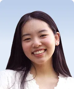 Smiling person with long dark hair.