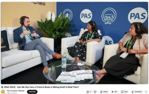 Researchers conversing on white couches at PAS