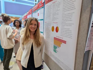 Conference poster session with attendees talking