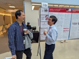 Researchers chatting in front of poster display