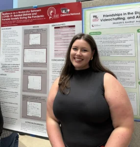 Woman presenting scientific poster at conference