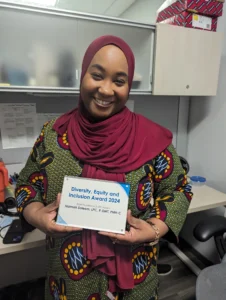Individual displaying a diversity and inclusion plaque