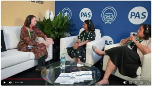 Panel discussion with PAS logo backdrop and table