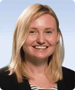 Smiling blonde woman in black blazer