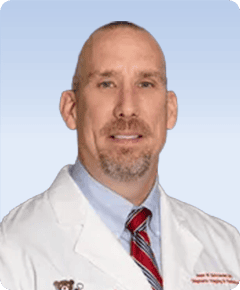 Male physician in white coat and tie