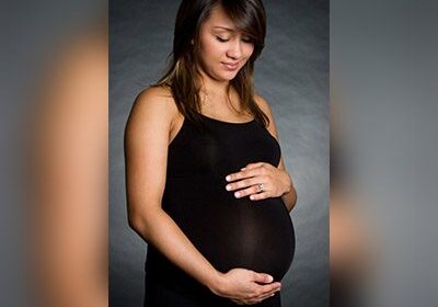 Pregnant woman in a black tank top.