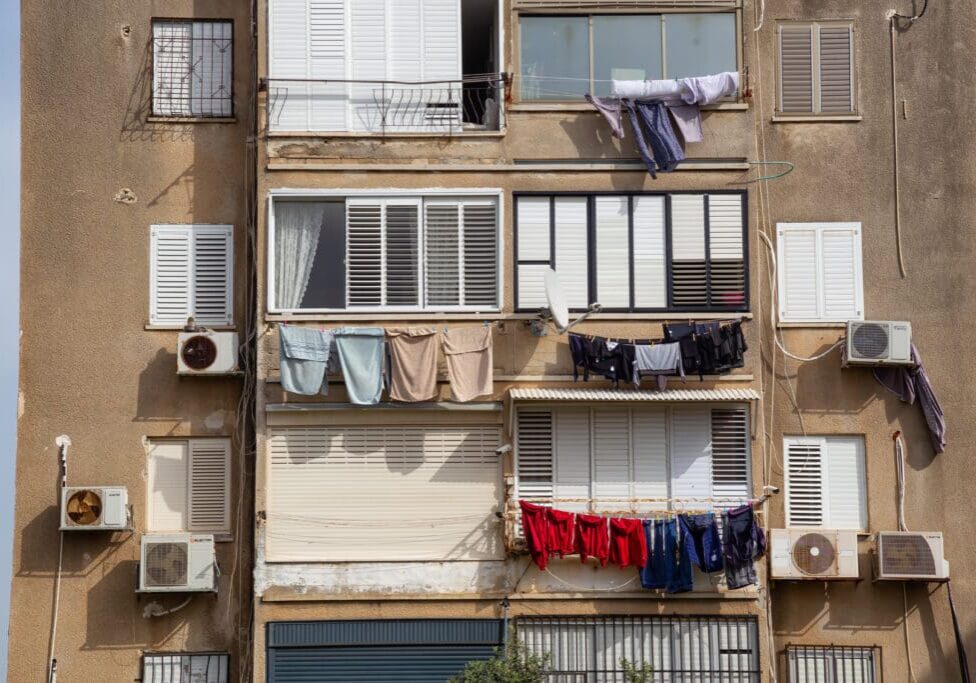 Apartment building with laundry hanging outside.