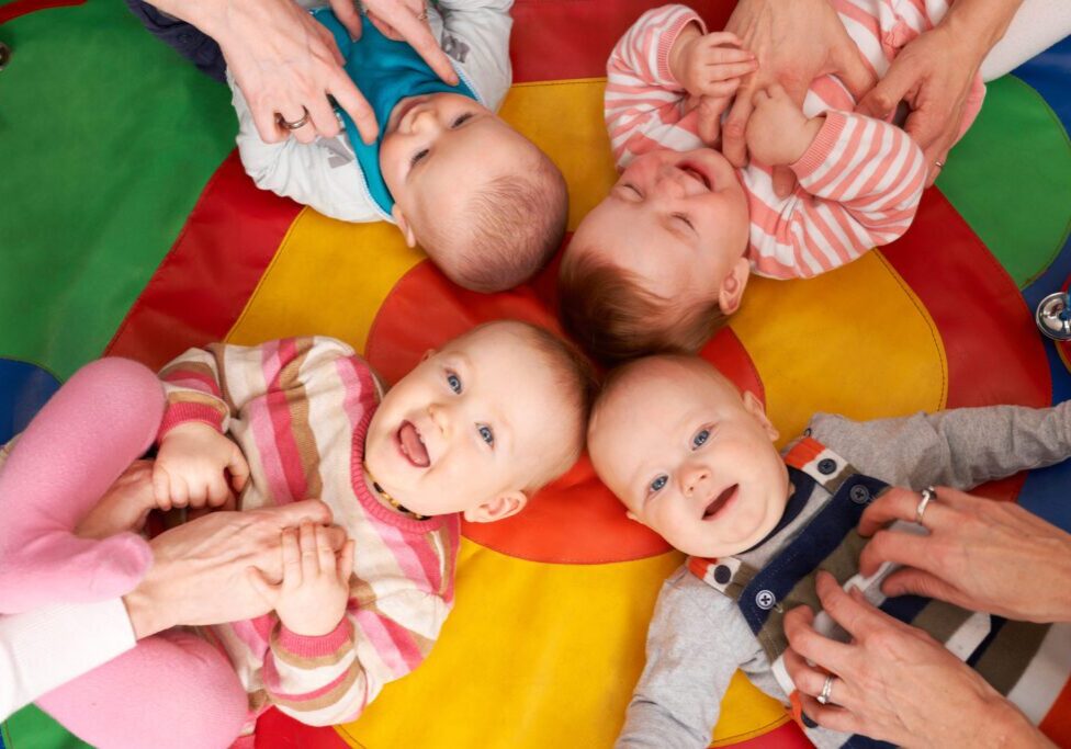 Overhead View Of Babies Having Fun At Nursery Playgroup