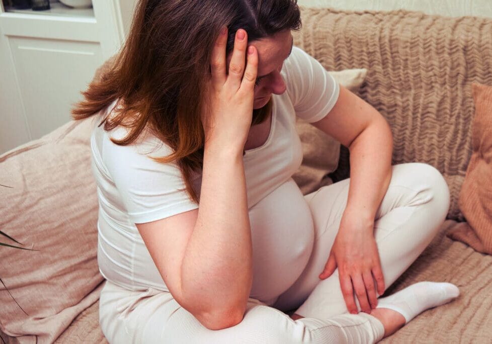 Caucasian pregnant woman having headache