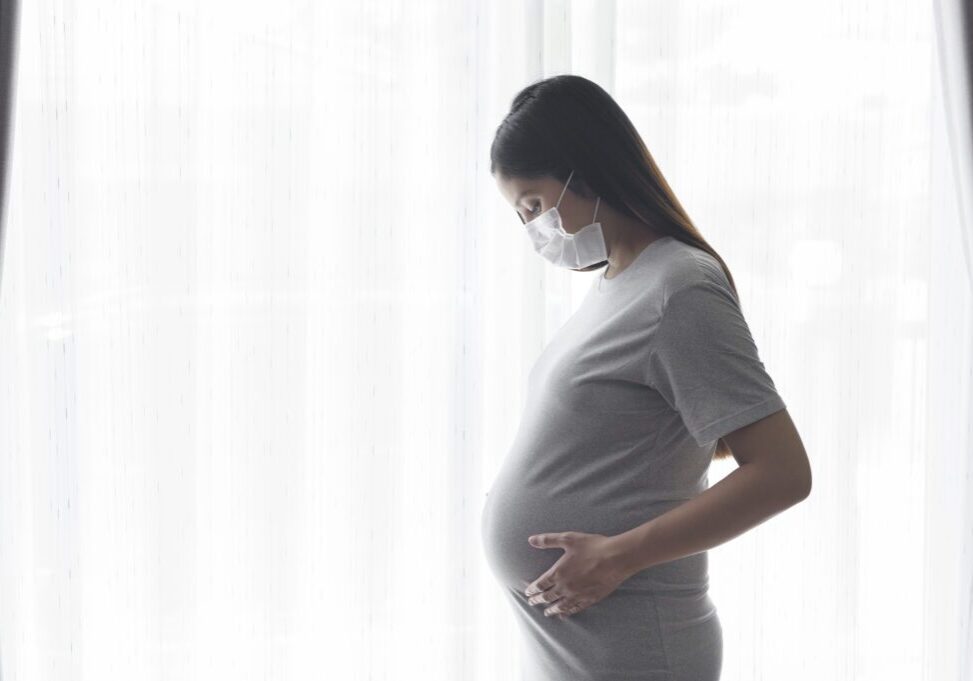 Young Pregnant Woman Wearing A Protective Mask And Expecting A B